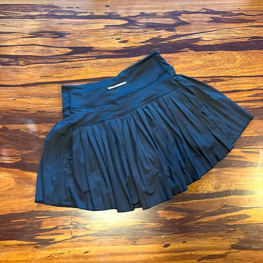Black goldhinge mini pleated skirt. New without tags. Sz small